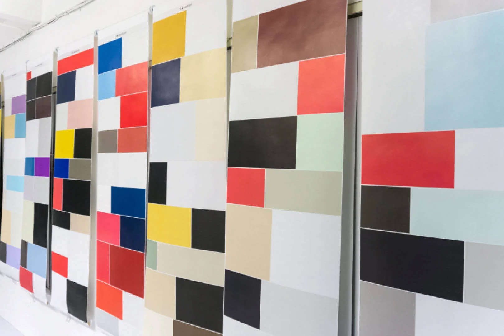 MUD Foundation Filio Gálvez’s *Window Blinds from the GIS (Google Image Search) Series*, 2017, featuring a series of vertical panels composed of colorful geometric rectangles and squares arranged in abstract grid-like patterns.