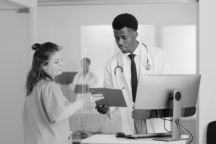 A doctor and nurse discussing sensitive patient information