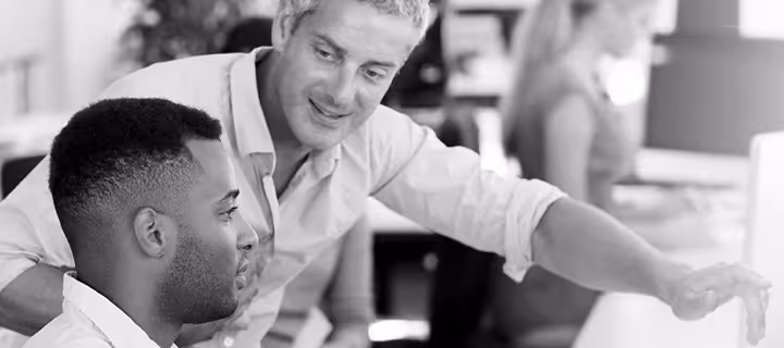 A business professional training a new employee