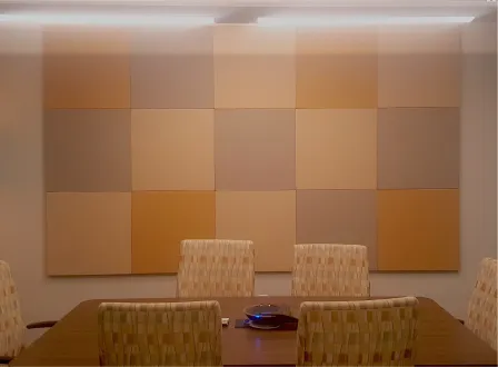 A table with four chairs in front of a wall with a brown and tan color scheme.