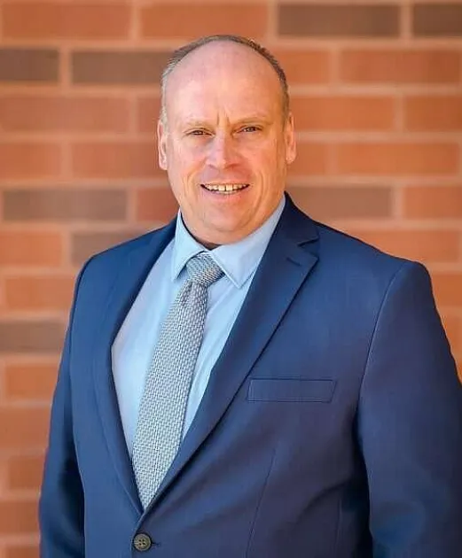A man wearing a blue suit and tie.