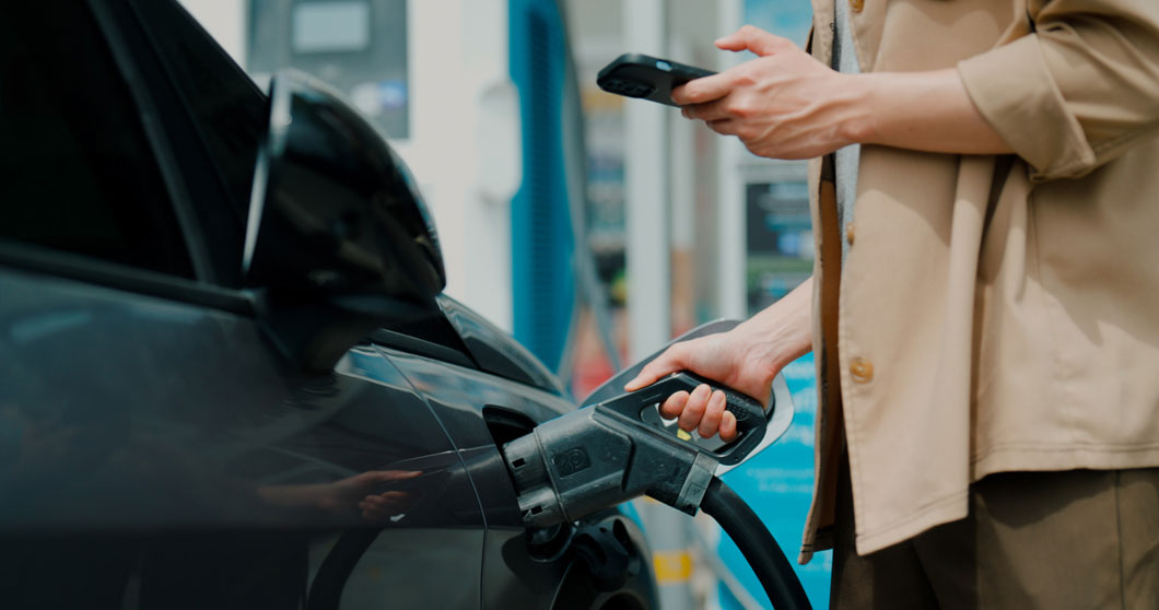 A man accessing EV charging with the AmpUp App on his mobile phone