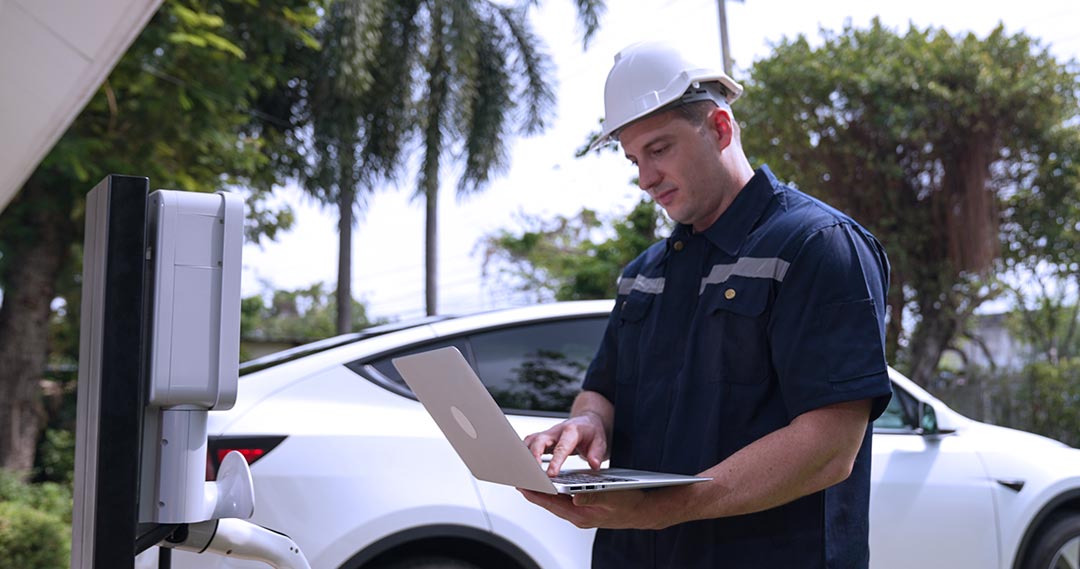 Licensed EV technician performing regular charger maintenance