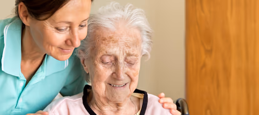 This image is representing occupational therapy and there is a caregiver and older women in the image