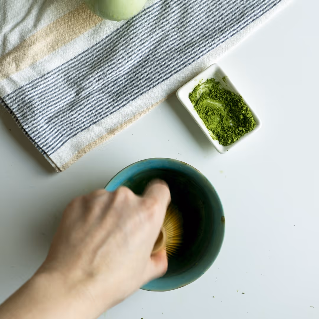 mano che mescola tè verde matcha