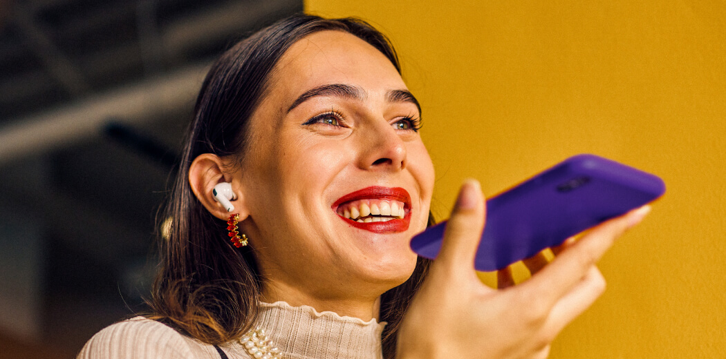 A woman holding a purple phone