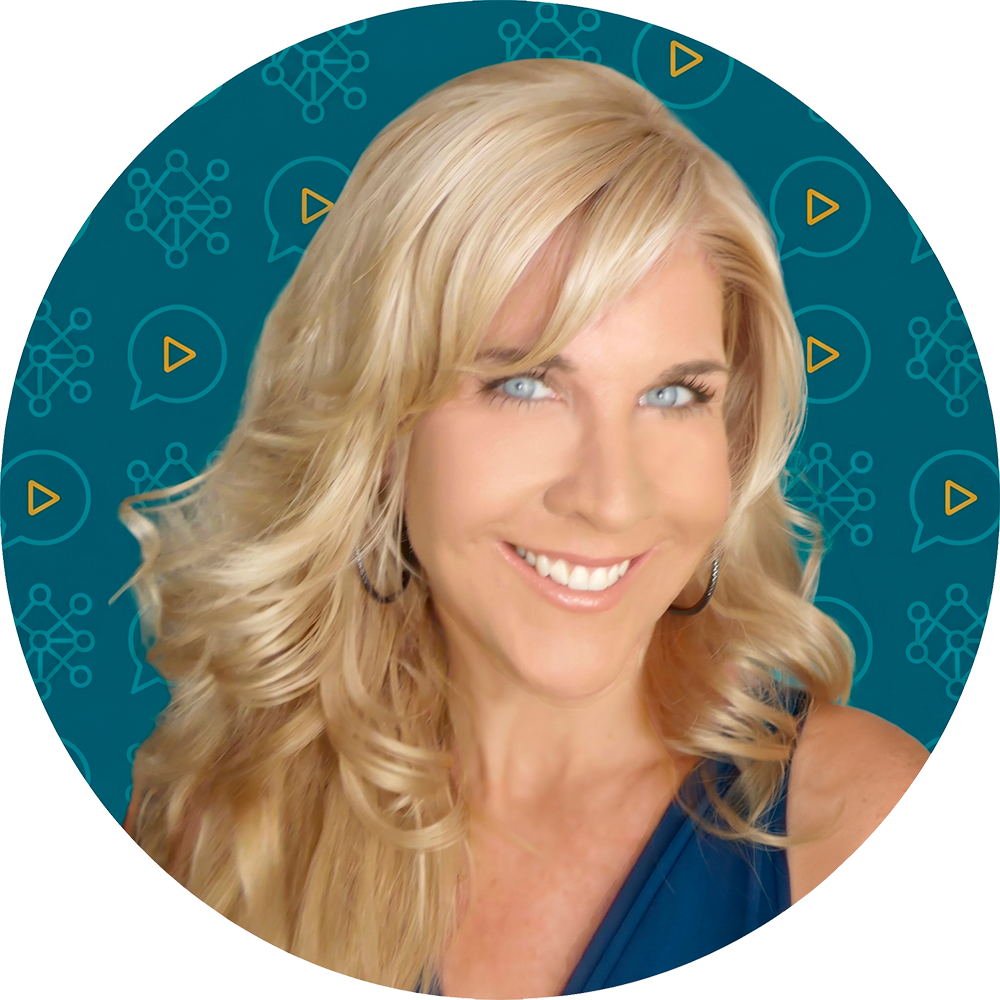 Close-up portrait of a smiling woman with long blonde hair and blue eyes.