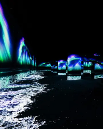 Witness the splendor of the aurora being at odds with the fierce waves
