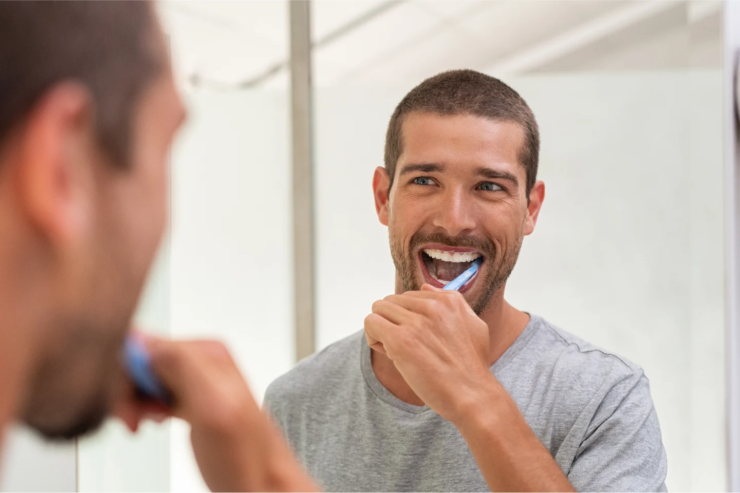 man brushing teeth before and after breakfast