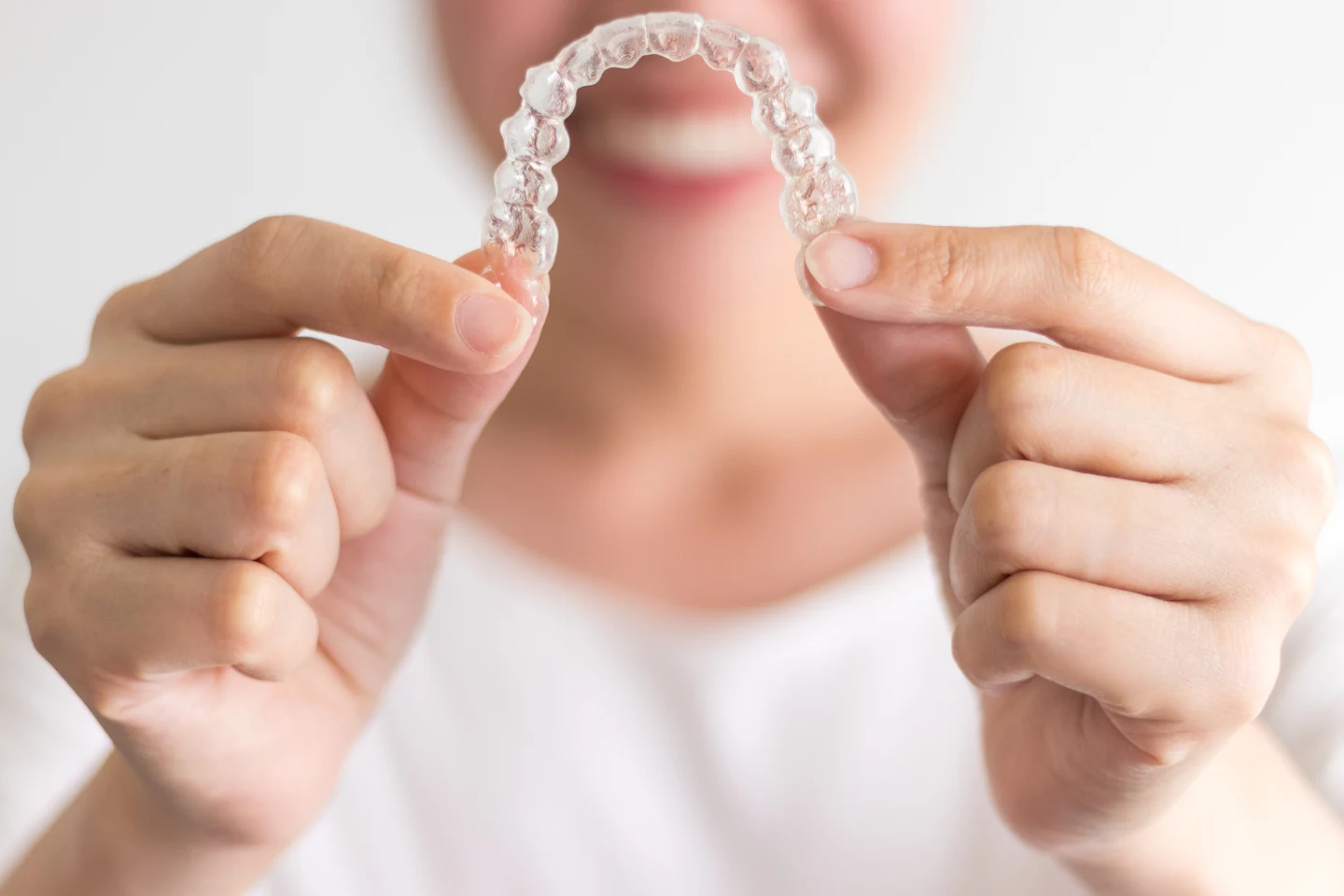 woman holding Invisalign
