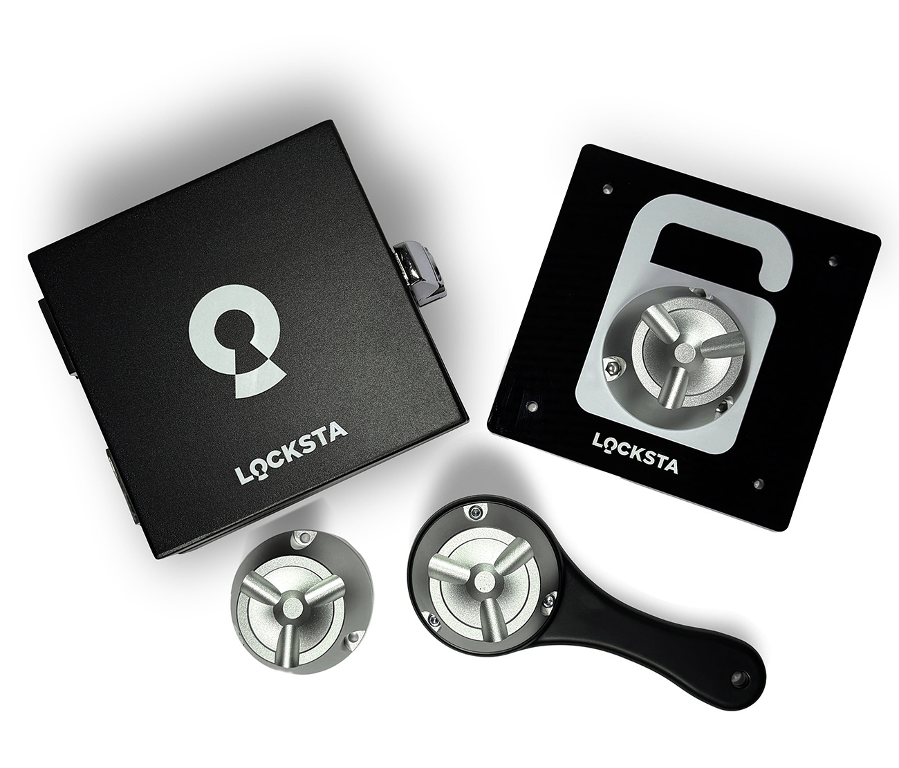 Schwarzes LOCKSTA-Verschlusssystem mit Schlüsselgriff und zwei separaten Metallteilen auf weißem Hintergrund.