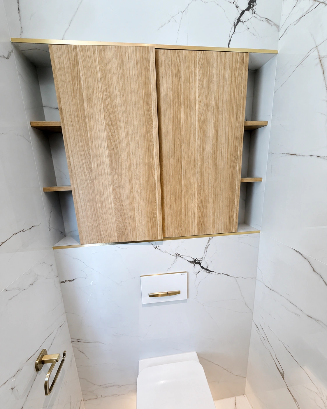 Bespoke timber storage above concealed toilet