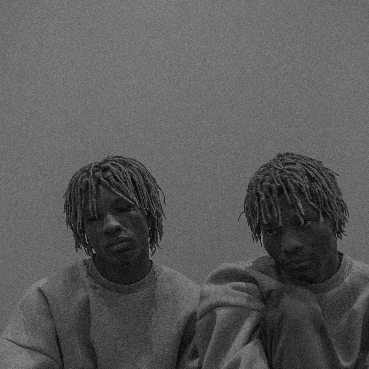 Two people with dreadlocks in black and white portrait photograph