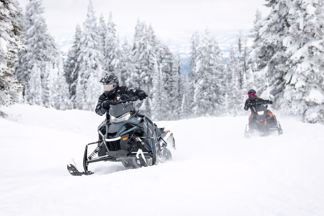 people riding snowmobile on trail to gaylord michigan