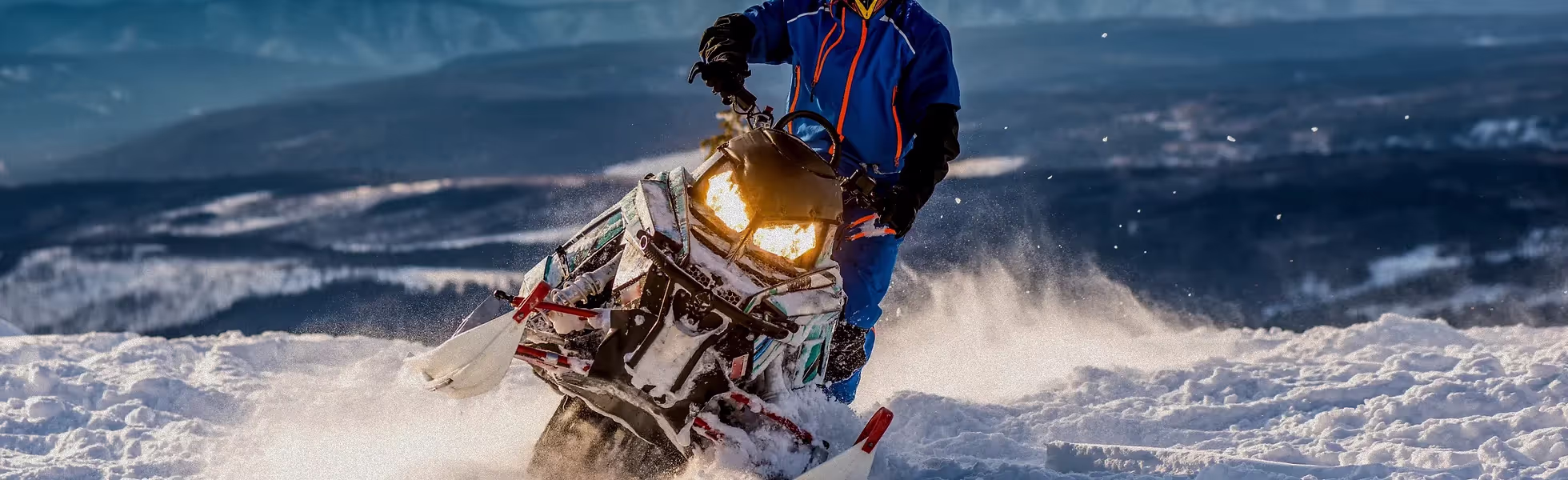 person snowmobiling in northern michigan