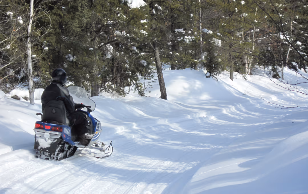 snowmobile rider on michigan snow trails