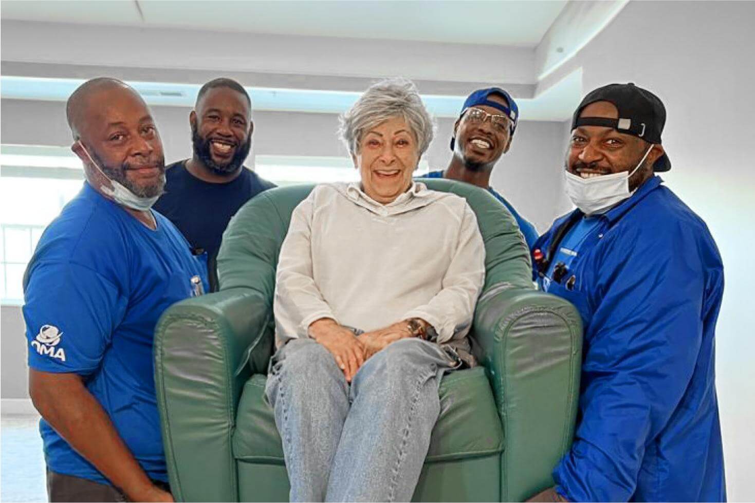 Movers helping middle age woman move into a new home