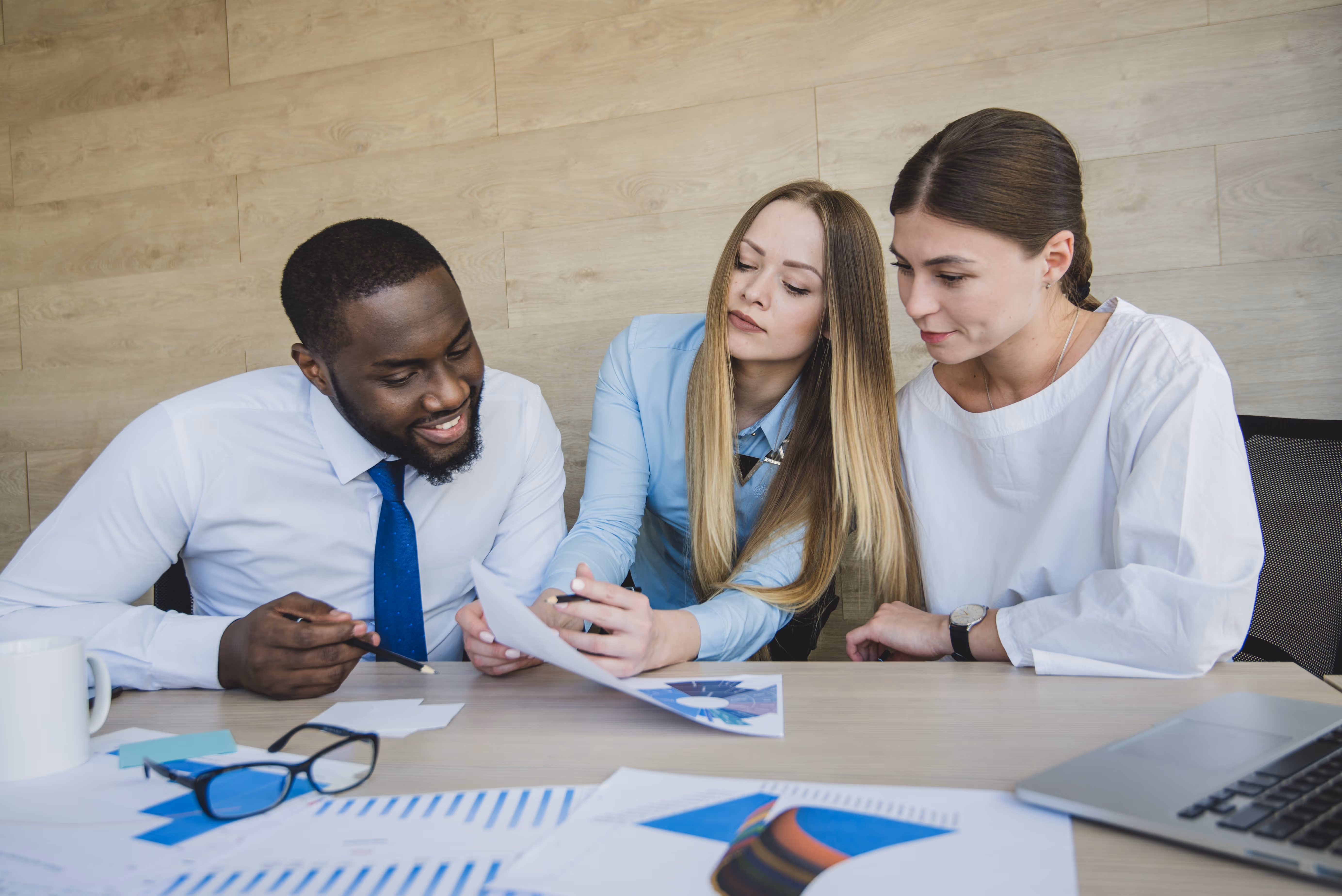 three business people with papers