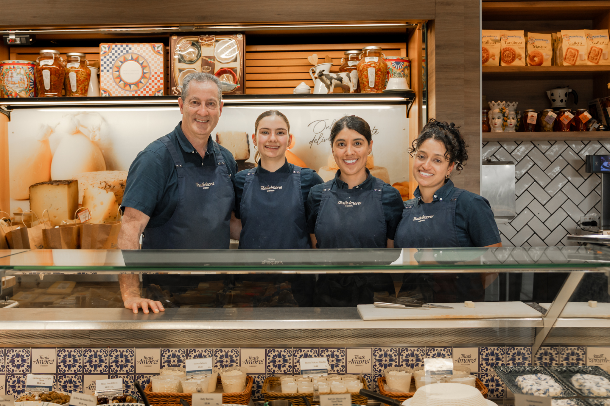 Cheesery employee serving a customer