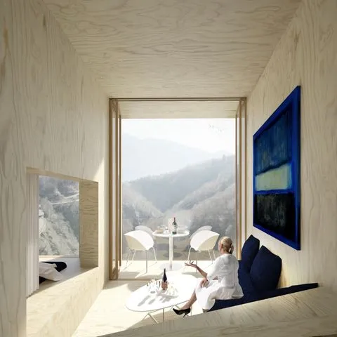 Photo de l’intérieur de la cabine Pizzo Vogorno avec vue panoramique sur les montagnes, illustrant le luxe minimaliste et l’expérience unique pensée par Momerable.