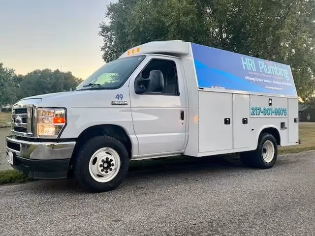 A HRI Plumbing Company tuck standing in a residential area