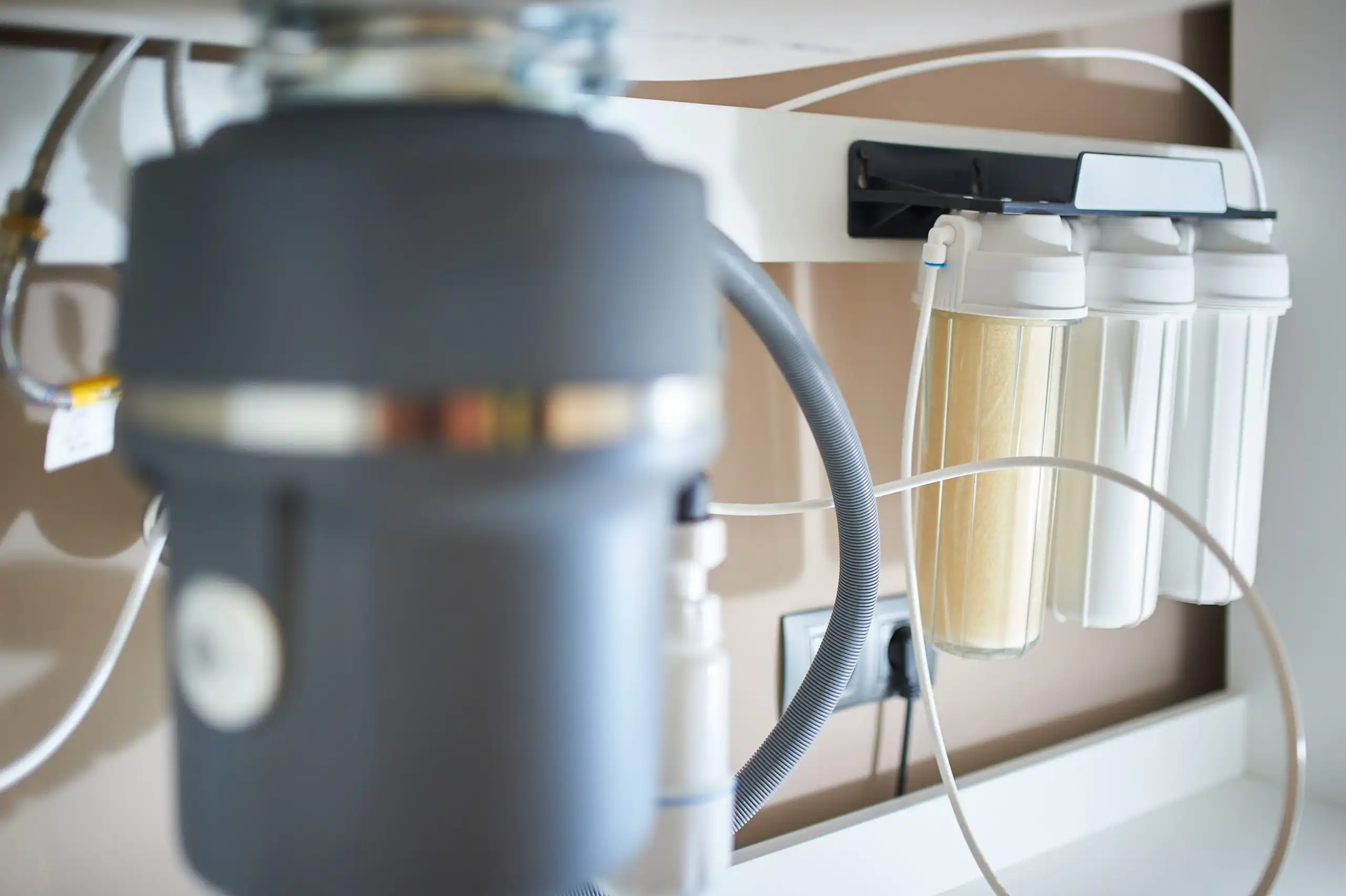 Under-sink water filtration system and garbage disposal.