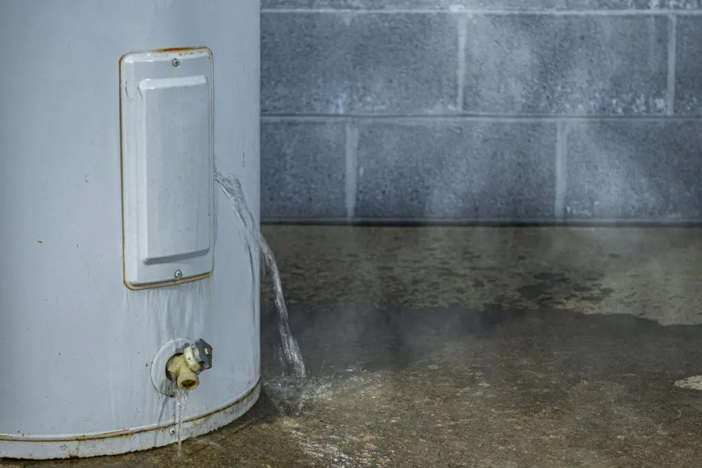 Water leaking from leaking water heater onto floor.