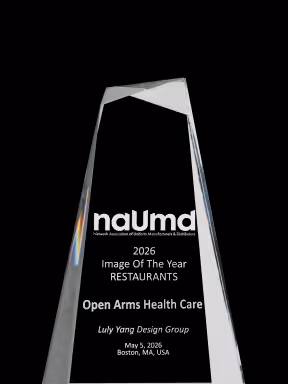 Glass award engraved with NAUMA Image of the Year 2026 for Open Arms Health Care by Luly Yang Design Group.