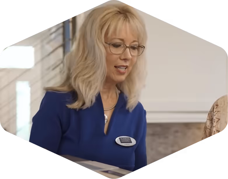 Woman in a blue shirt working with a client on a kitchen design project