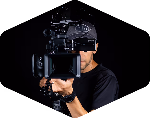 Man filming on a large, professional grade video camera