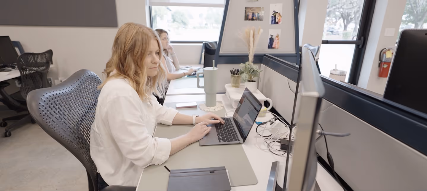 Marketing professionals working at open office desks on digital advertising campaigns and content strategy.