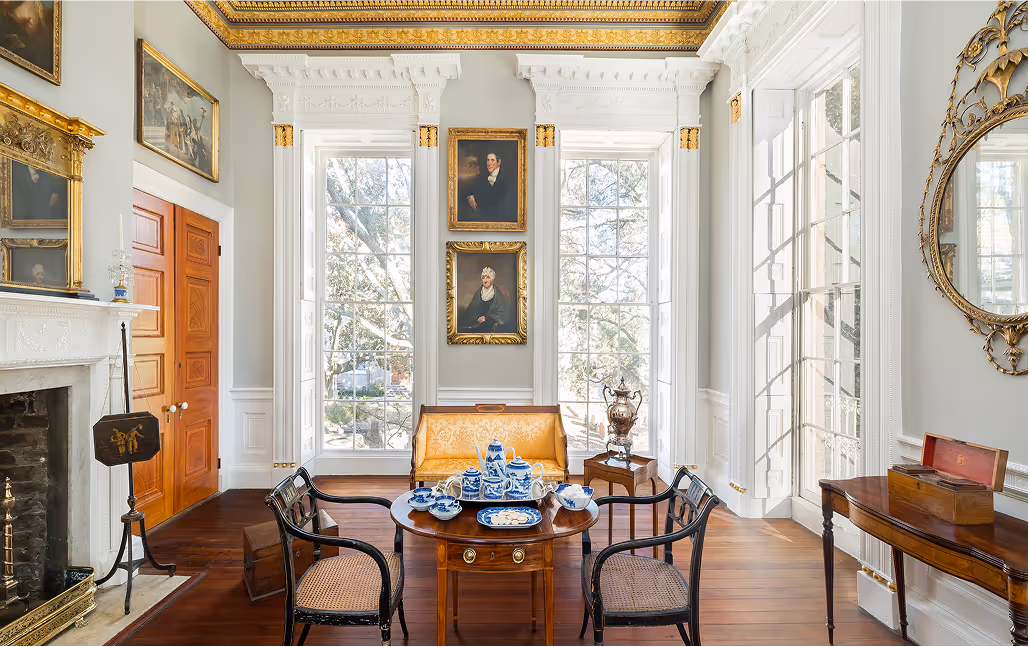 Elegant antique sitting room with large windows in a southern mansion