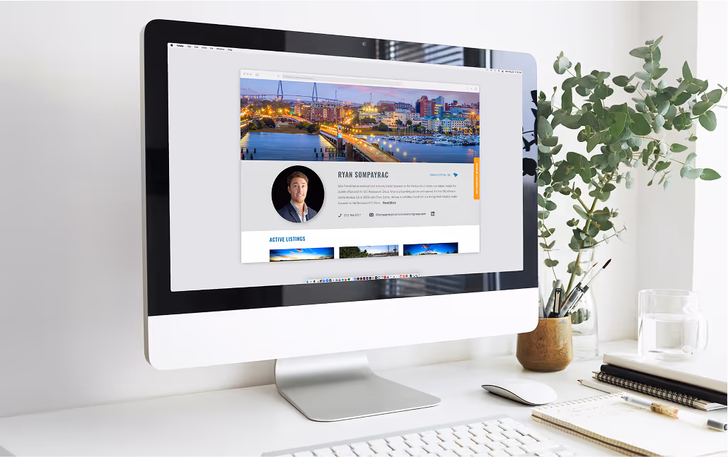 Large iMac on a clean white desk displaying a website designed by Target Market