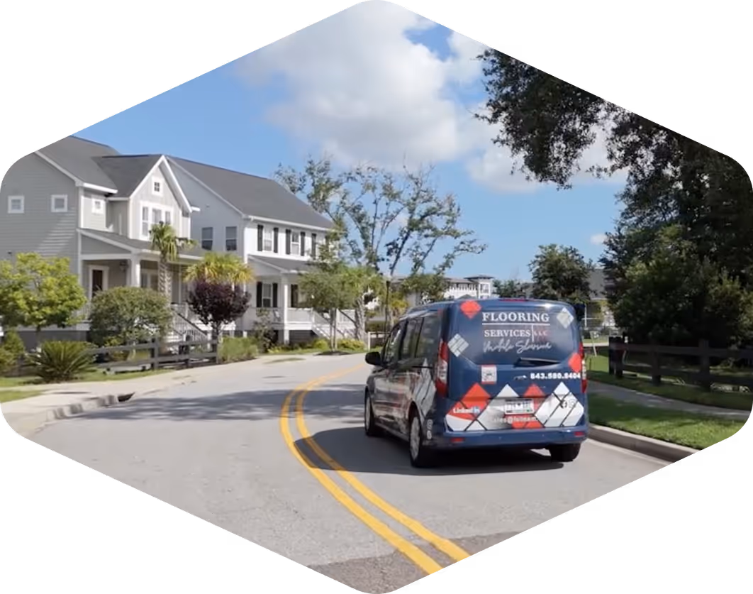 Flooring Services LLC van driving through residential Charleston neighborhood for mobile showroom appointment.