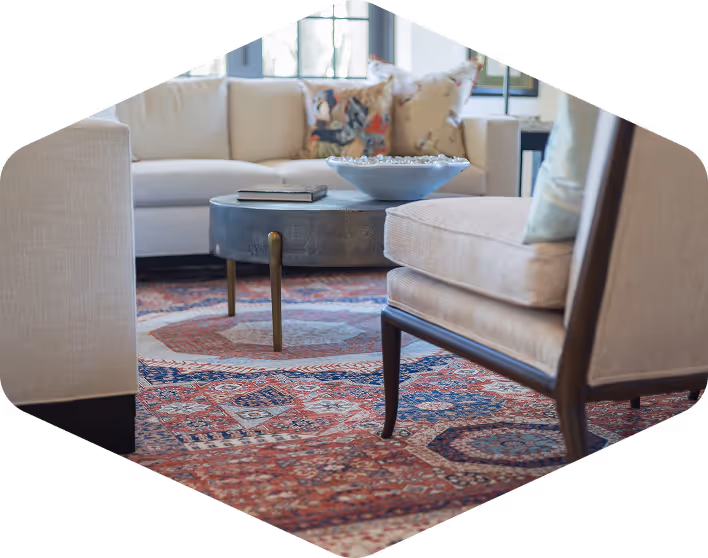 Cozy, well-appointed living room with Persian rug and neutral furniture designed by Alexandre Fleuren Interiors