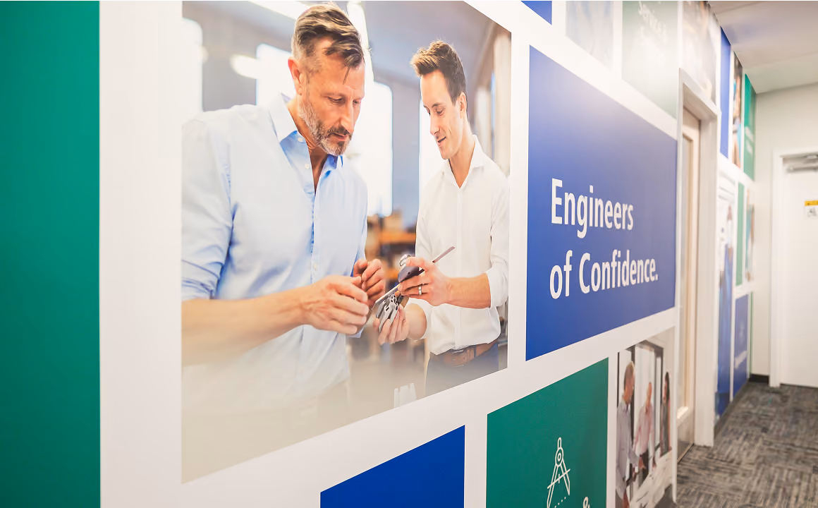 Belimed promotional imagery displayed on a large wall in a commercial location
