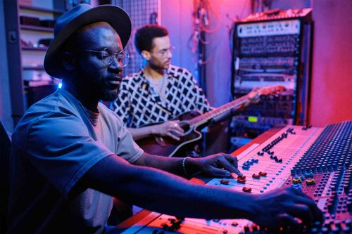 Two musicians recording in the studio