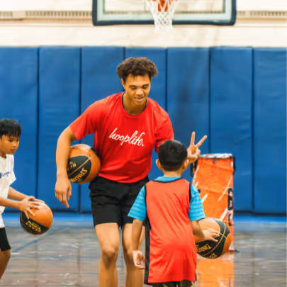 Coach giving a peace sign to a kid
