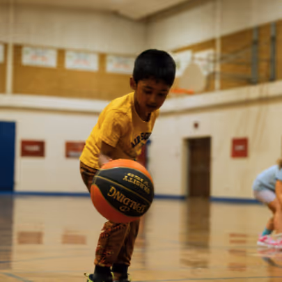 Kid learning how to dribble 