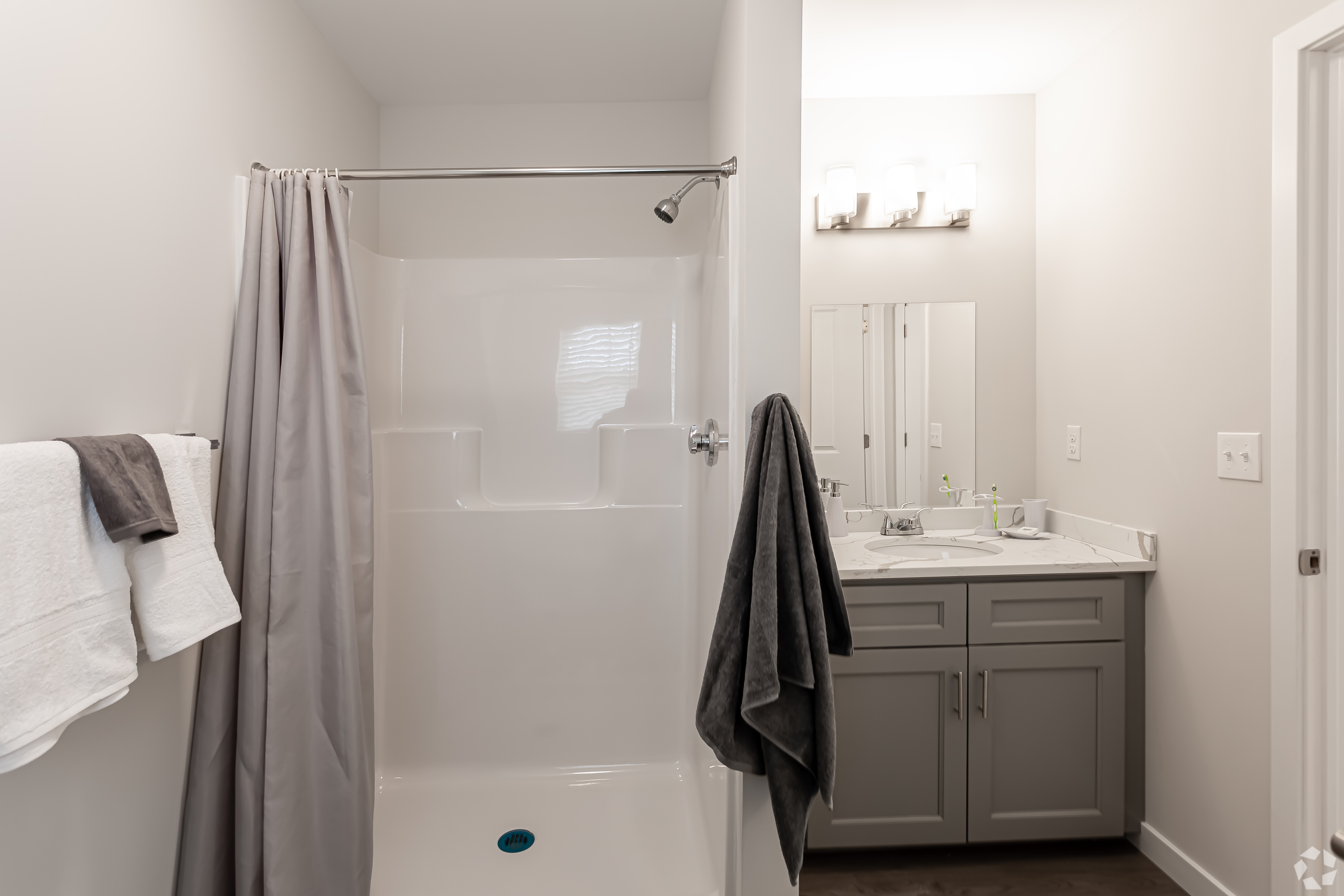 Bathroom with shower and sink vanity