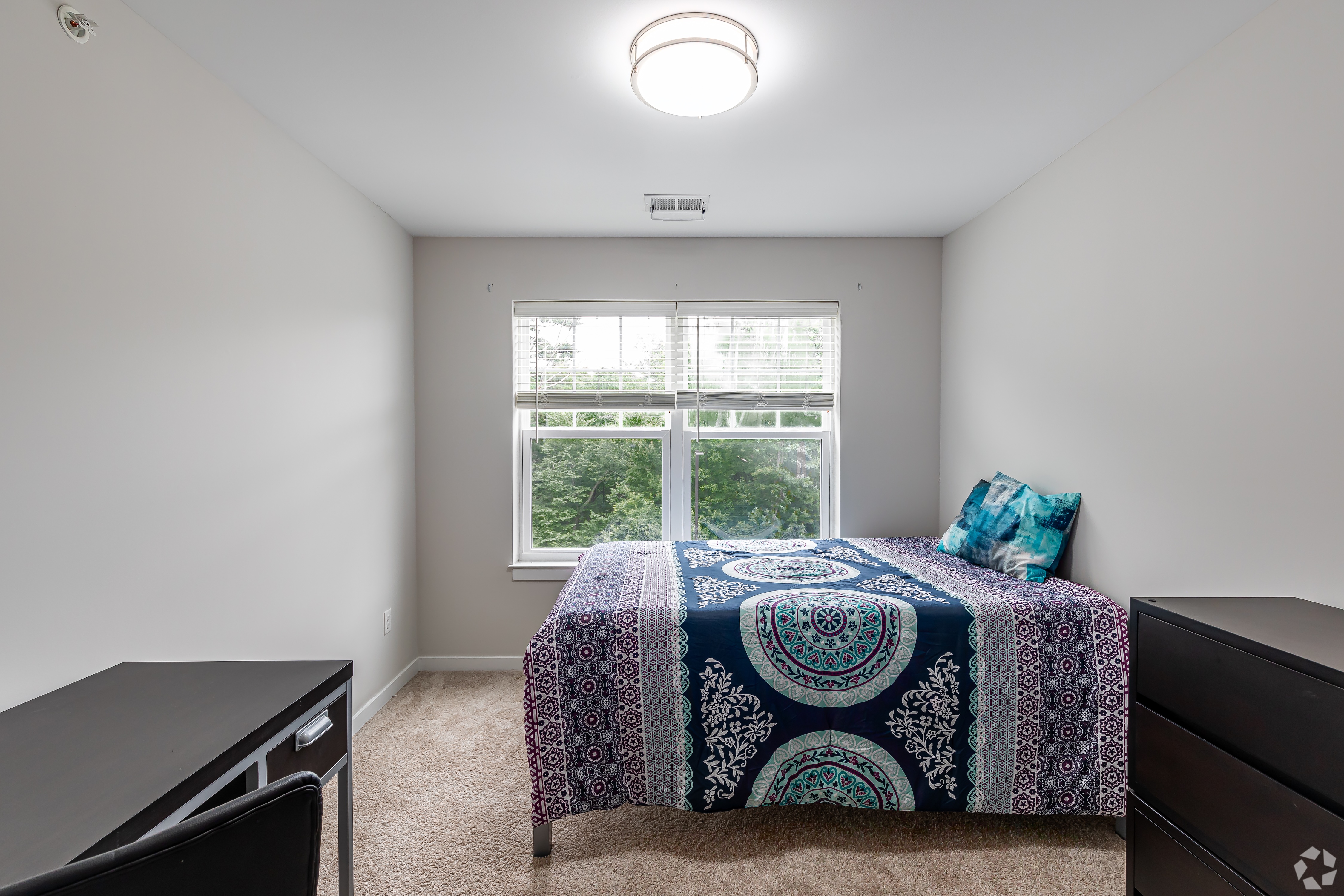 Bedroom with made bed and window
