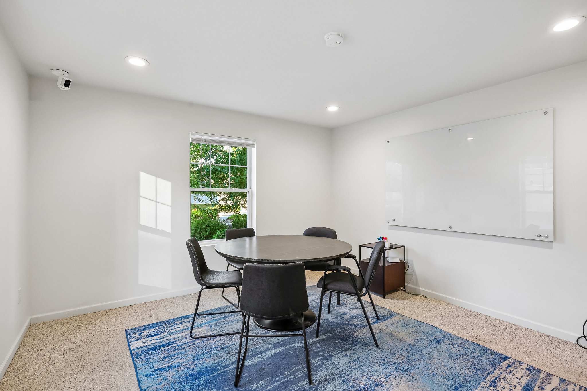 Business center with table and chairs and white board