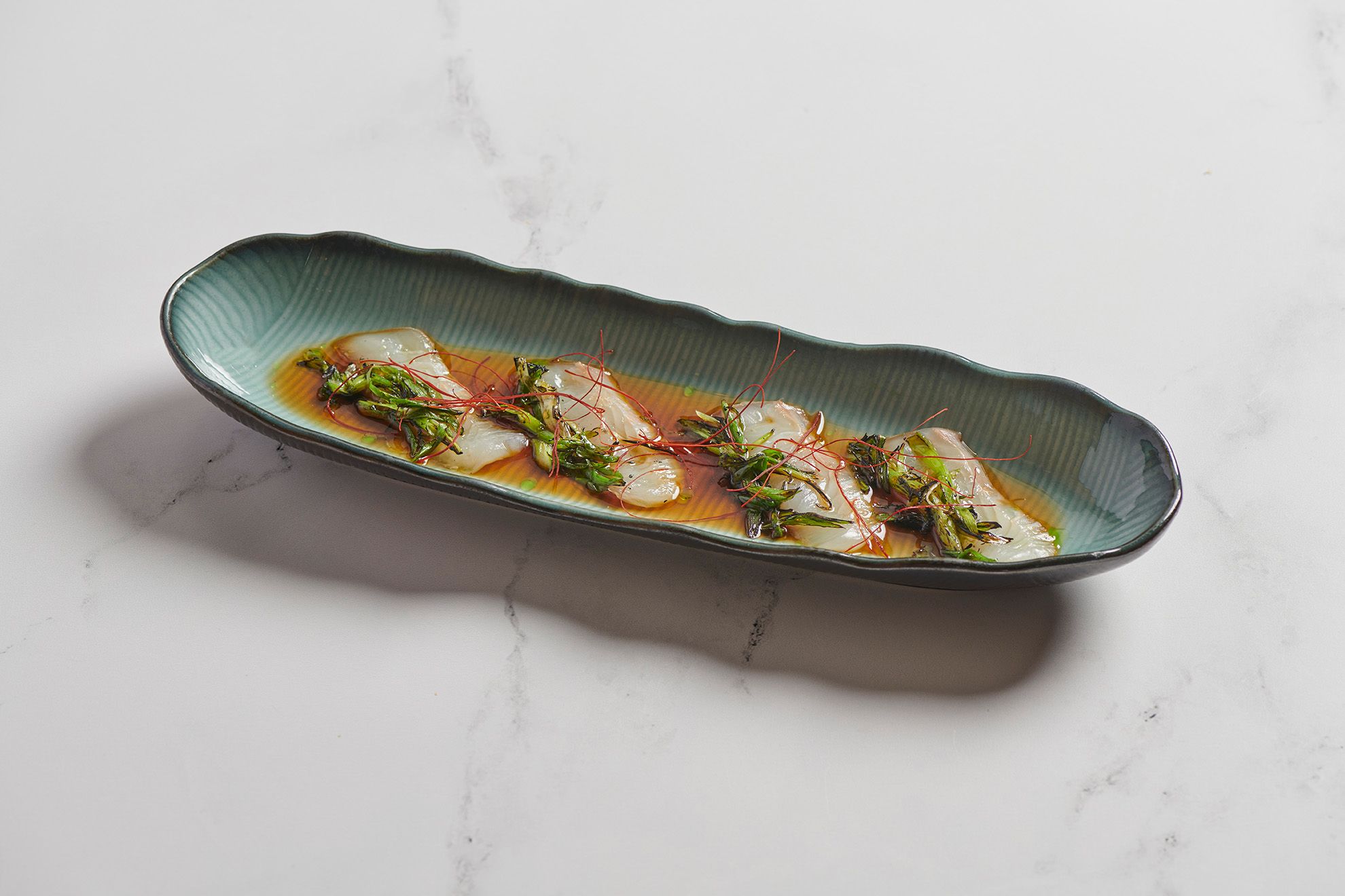 A closer look at how fluke, burnt scallion, and togarashi thread shape flavor with restraint and clarity at Kaido Sushi in Arlington Heights, IL.