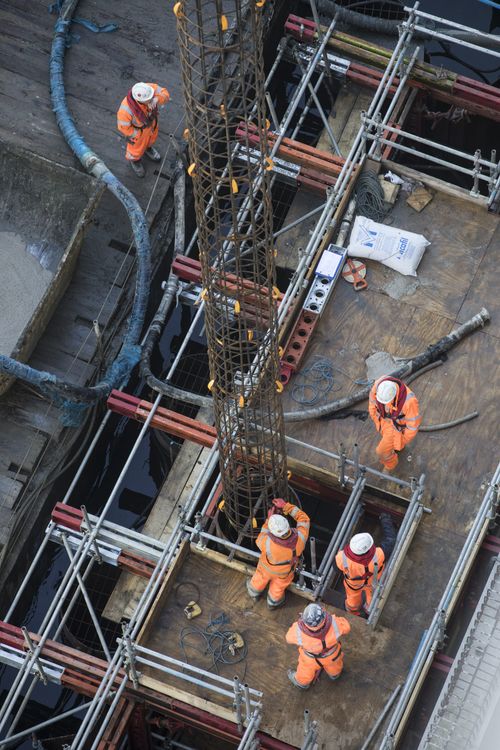 Operatives installing piling casings from a temporary platform.