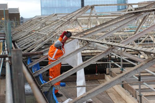 Close up of an operative dismantling the station roof.