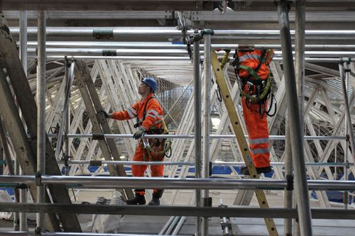 Close up of operatives dismantling the station roof.