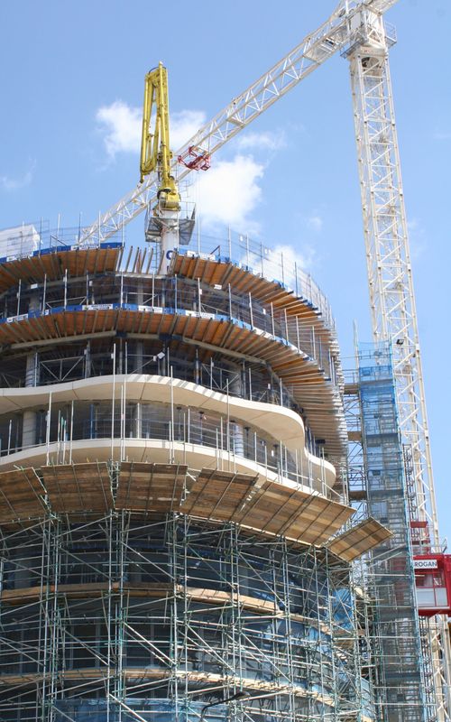 Close-up of a scaffold and high rise tower as construction continues.