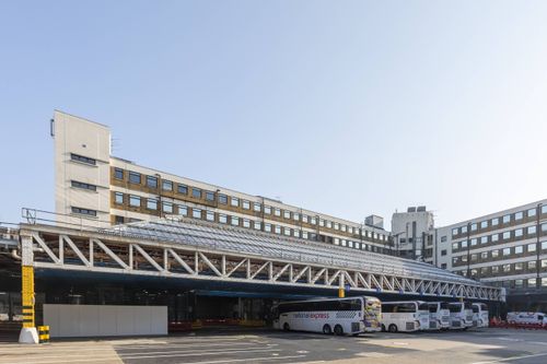 Scaffold deck installed above active coach station.