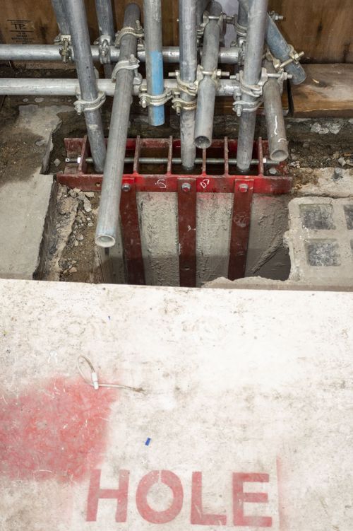 Steel brackets and scaffold tube arrangement.