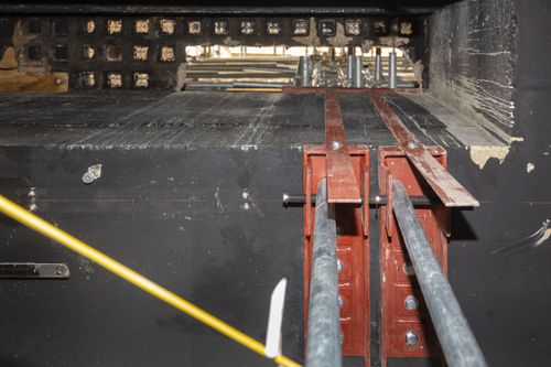 Steel brackets bolted to RC wall.